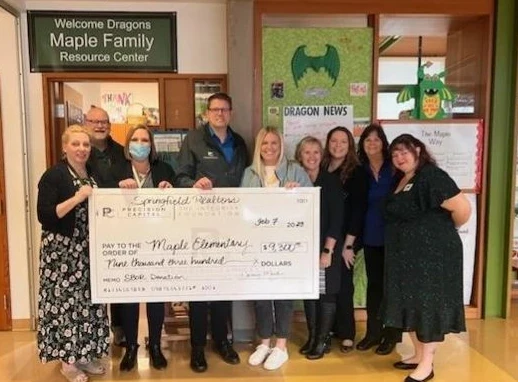 Precision Capital team presenting an Integrity Foundation donation